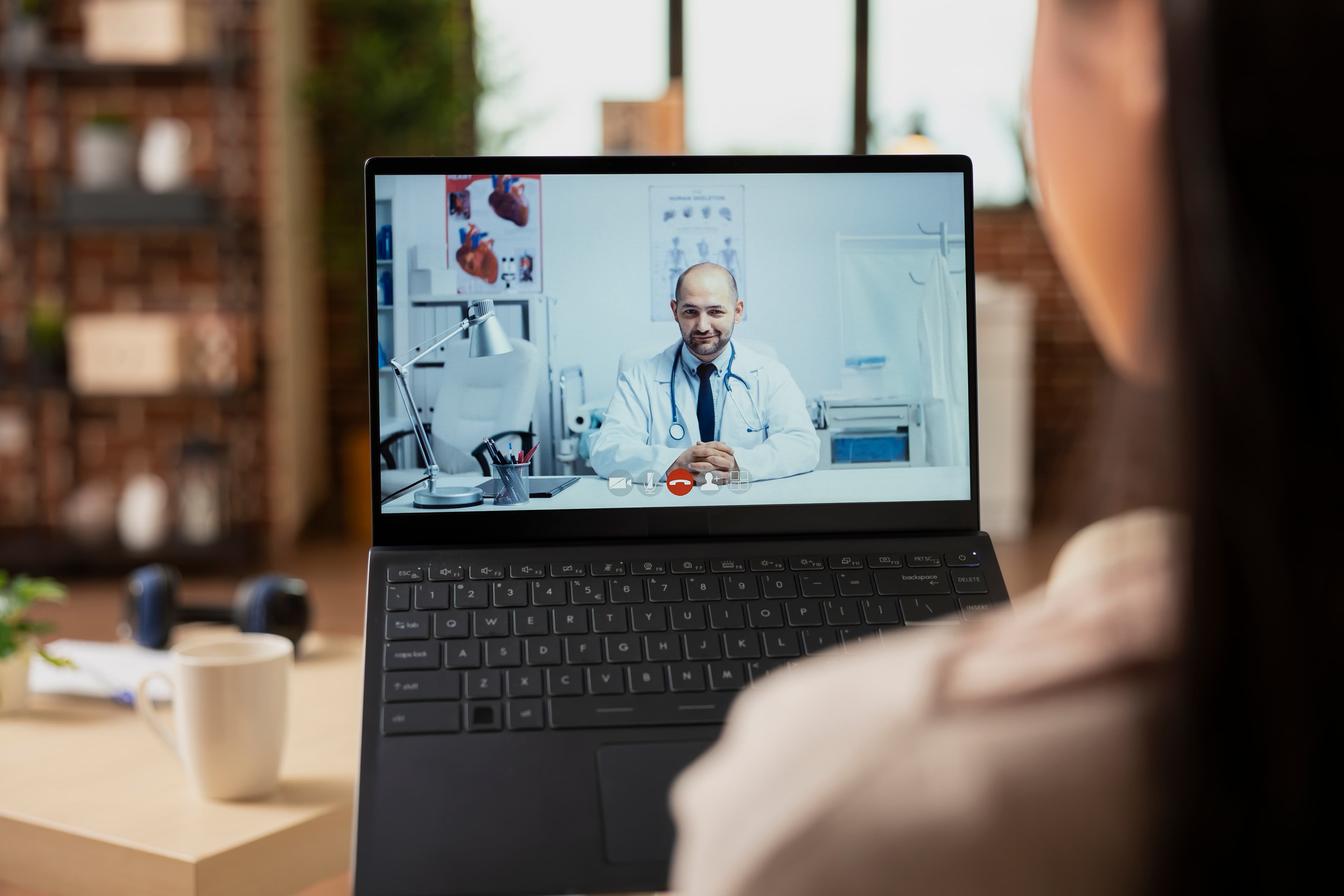 Female doctor in white coat providing virtual consultation